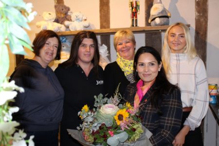 Priti Patel with staff and customers at Oakleys of Coggeshall receiving her bouquet