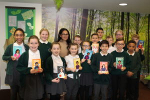 Priti Patel MP with pupils at the Stanway Fiveways Primary School, holding the new books the MP donated to their library.