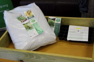 The starter pack, including a planter, a potting tray, a bag of compost and a selection of seed packets for vegetable and salad plants
