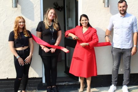 Priti Patel cuts the ribbon to formally open the Matrix Hair & Beauty Academy with from left Academy team member Paris Sellick and owners, Natalie and Kyle Worster.