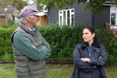 Ralph Hayter, owner of Daymens Hill Farm discusses the fruit business with Priti Patel during her tour of the orchards.