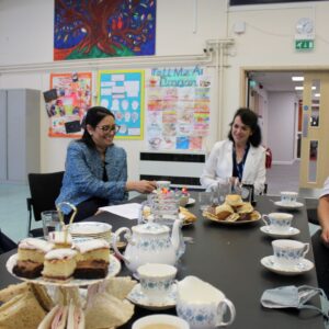 Priti takes cream tea with Katie Mason (left), Susannah Edom-Baker - CEO of Attain Partnership Trust which runs the School (far end of table) and Tina Townsend of Acacia Business Services Ltd