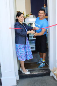 Priti Patel MP, with proprietor Paul Long, cutting the ribbon to formally declare Café Bijou open.