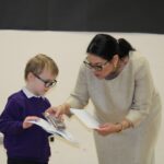 Runner up, Oliver Stephenson aged 4, receiving his trophy and a printed copy of the winning entry from Priti Patel.
