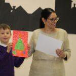 Runner up, Louie Cullum, aged 7, receiving his trophy and a printed copy of the winning entry from Priti Patel.