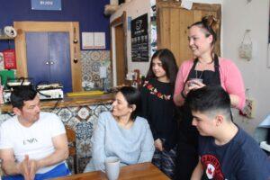 Priti Patel with Paul and Lucie Long and their two children Sophia and Charlie at the Café Bijou, Coggeshall.