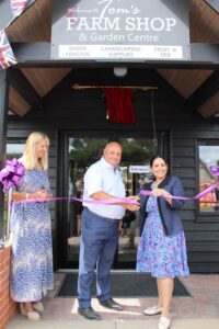 Priti Patel MP cuts the ribbon to declare the revamped Tom’s Farm Shop & Garden Centre formally open, alongside its owner, Tom Gregan and his wife, Nikki.