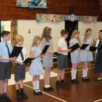 Pupils at Feering Primary School read out a poem, for Priti