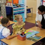 Pupils at Baynards Primary School, Tiptree discuss their Get Witham Reading Books with Priti Patel