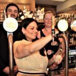 Priti Patel MP pulls a pint alongside Management Partners Laura Smith and Rogan Wickham during her tour of The Angel, Kelvedon.
