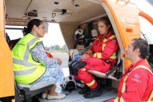 Priti Patel MP, aboard the emergency helicopter, talks to Critical Care Paramedic Zoey Spurgeon (opposite) and duty Doctor, Will McGuiness. Shortly after this photo was taken, the helicopter and team took off to respond to an emergency call.