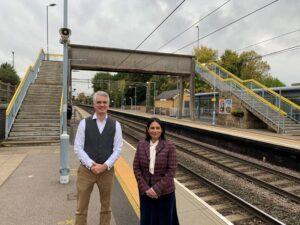 Priti Patel MP and James Cartlidge MP on the platform by the footbridge that has to be negotiated by rail passengers at Marks Tey Station