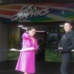 Priti cuts the ribbon to formally open GKs Graphics, alongside Clare Scammell.