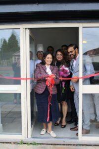 Priti cuts the ribbon to declare 7 Spices at the New Times open, alongside owner, Satin Singh, his wife Kalpana and staff