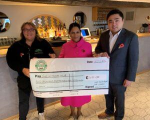 Priti Patel, with Alex Lai, owner of the AKA Restaurant & Lounge, presenting the cheque to Tina Townsend, Chair of the Board of Trustees of the Witham Hub.