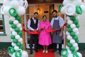 Priti Patel MP, with owners Ylli (left) and Abi Vata, cuts the ribbon to formally declare the Green Man, Little Braxted open.