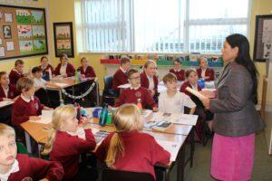 Priti Patel MP with pupils from class 4 at White Notley Primary School during her visit on 8th December 2022.