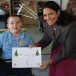 Priti Patel with Kyle Worland, aged 10, the winner of her annual Christmas card competition at Southview School.