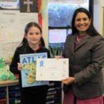 Priti presents Natalia Coyle, aged 9, with her runner-up certificate and prize at St Luke’s Primary School.