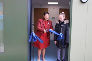 Priti cuts the ribbon to open the new classroom, alongside 11 year old Mia Scholey, Chair of the School Council.