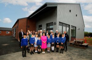 Priti and special guests with staff and students from Copford Primary School, in front of the new building