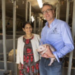 Priti with Fergus Howie of Wicks Manor Farm and one of his piglets