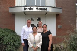 Priti with Inntel Chief Executive Douglas O'Neill and staff outside their headquarters in Feering.