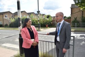 Priti speaks with NRA headteacher Simon Gibbs by the existing Conrad Road crossing