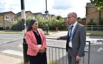 Priti speaks with NRA headteacher Simon Gibbs by the existing Conrad Road crossing