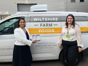 Priti with Charlotte Percy, Sustainability Executive at Wiltshire Farm Foods, with an example of the plastic trays used in their closed loop recycling system.